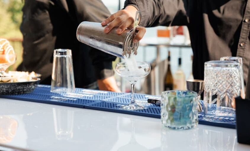 bartender-pouring-cocktail-in-portable-bar